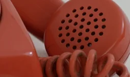 speaker of an old red phone 