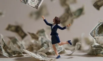 a plastic figurine dancing in money 