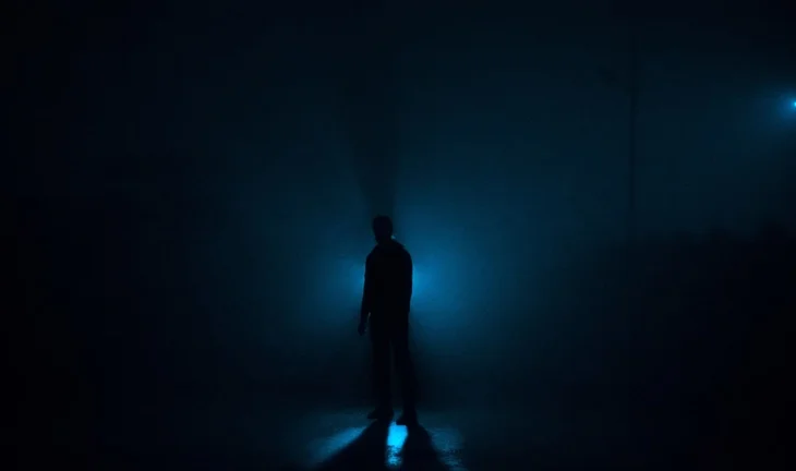 a man standing in the dark