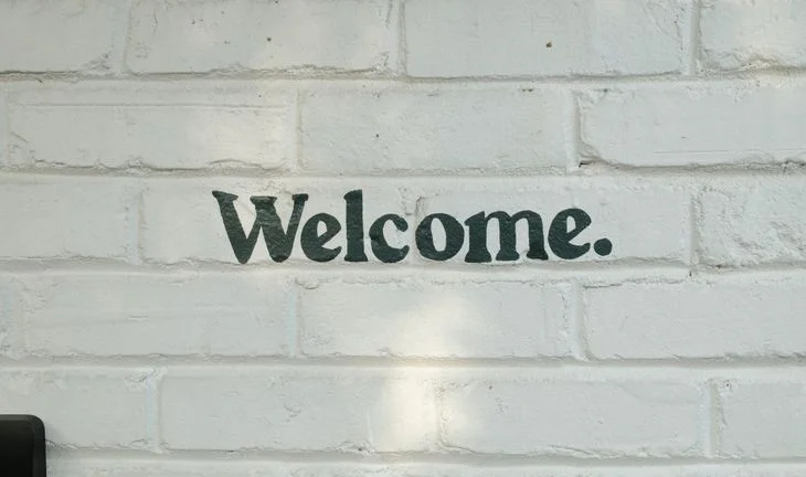 welcome written on a white wall