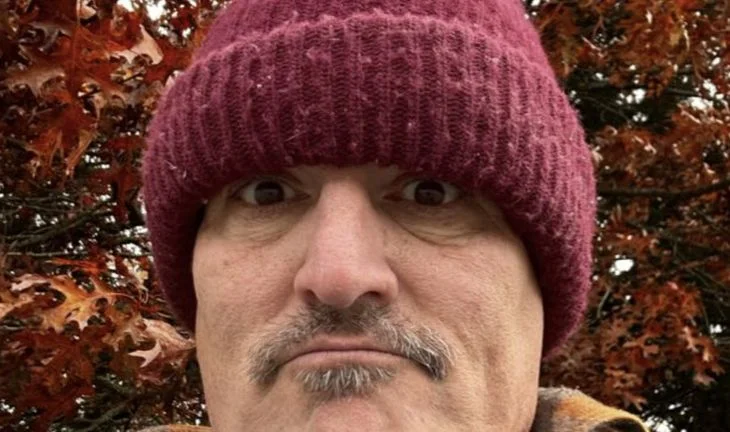 a man in a hat with a dog 