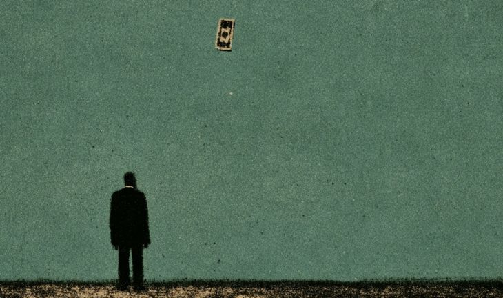 a man staring at a flying dollar bill