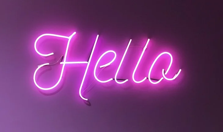 a pink sign that says hello