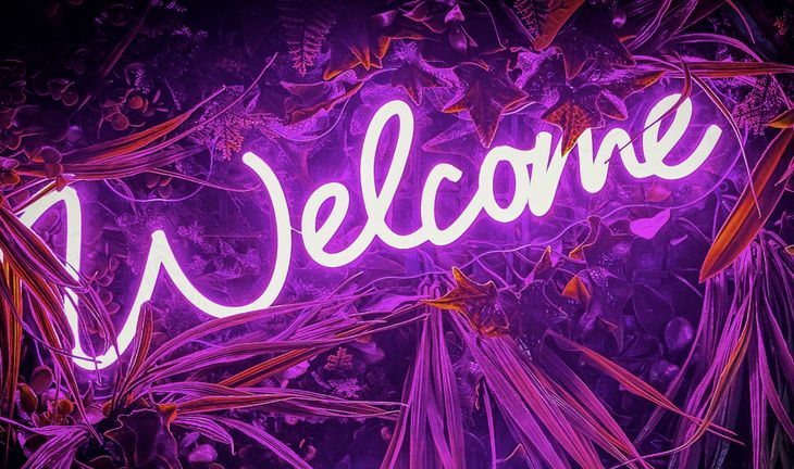 a pink welcome sign 